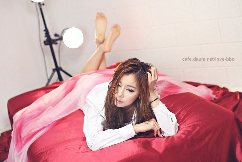woman on red bed with pink fabric