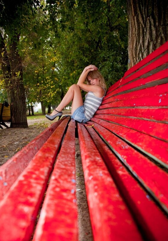 Woman on red bench in park