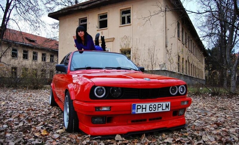 Woman on red BMW car