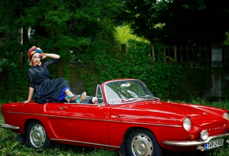 Woman on Red Car — Dramatic, Afternoon, Photograph, Trees