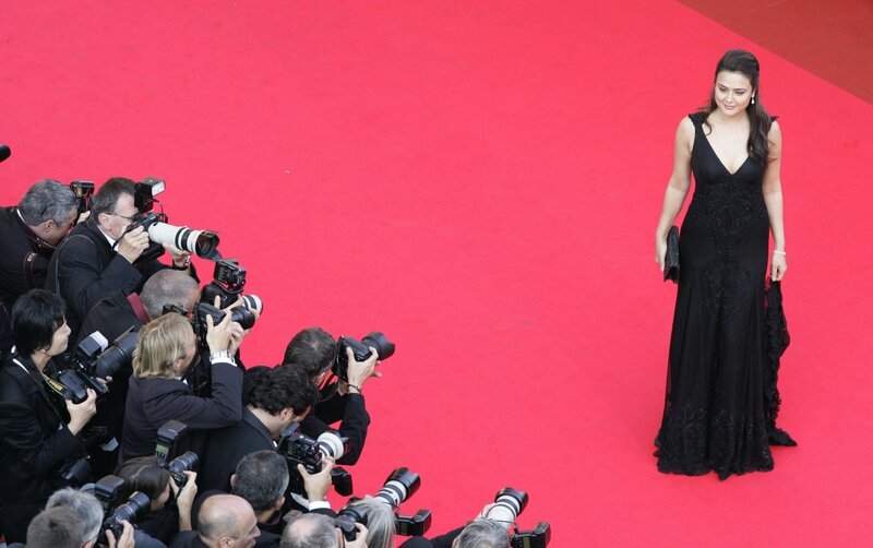 woman on red carpet with photographers