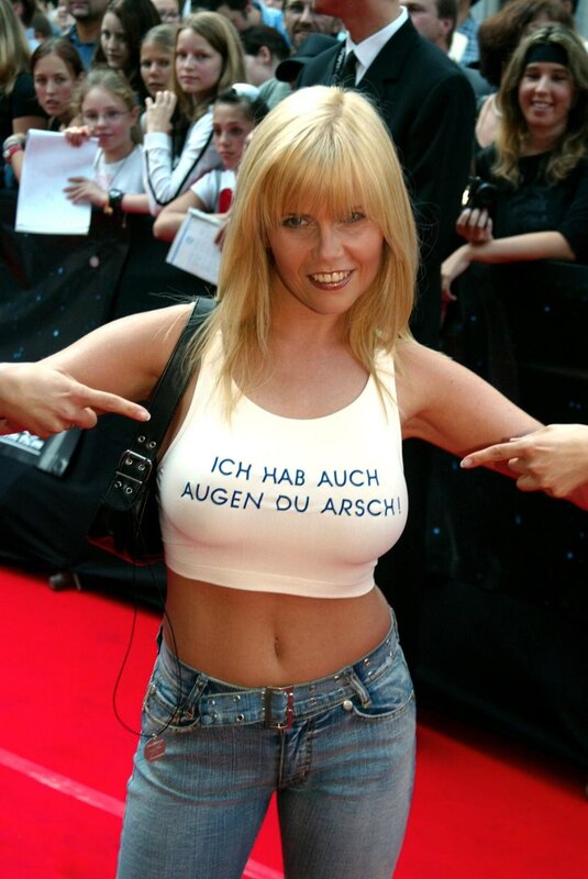 Woman on red carpet with text shirt
