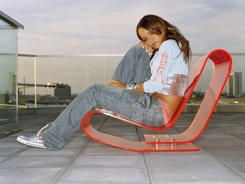 Woman on red chair on rooftop