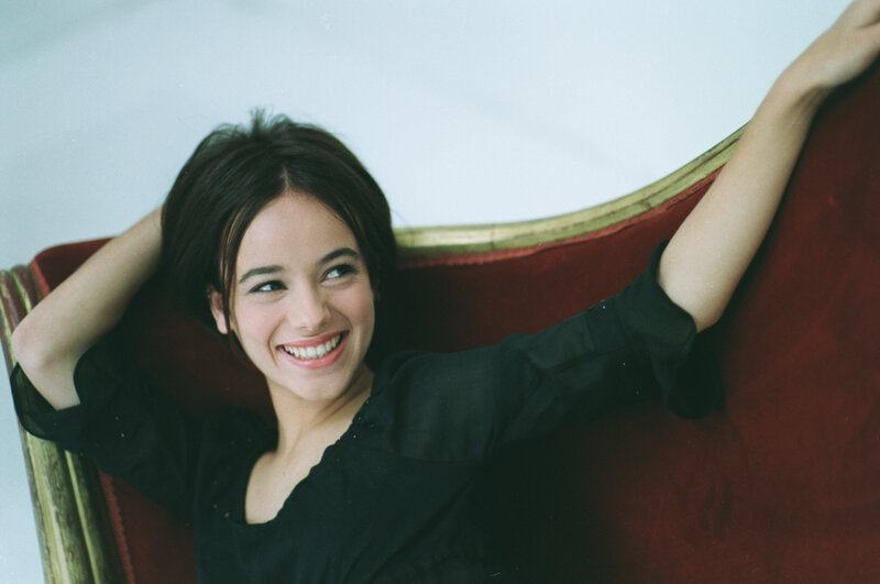 Woman on Red Couch — Relaxed, Photograph, Black Shirt
