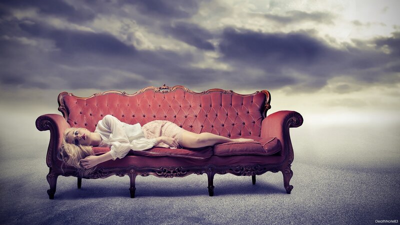 Woman on red couch under stormy sky