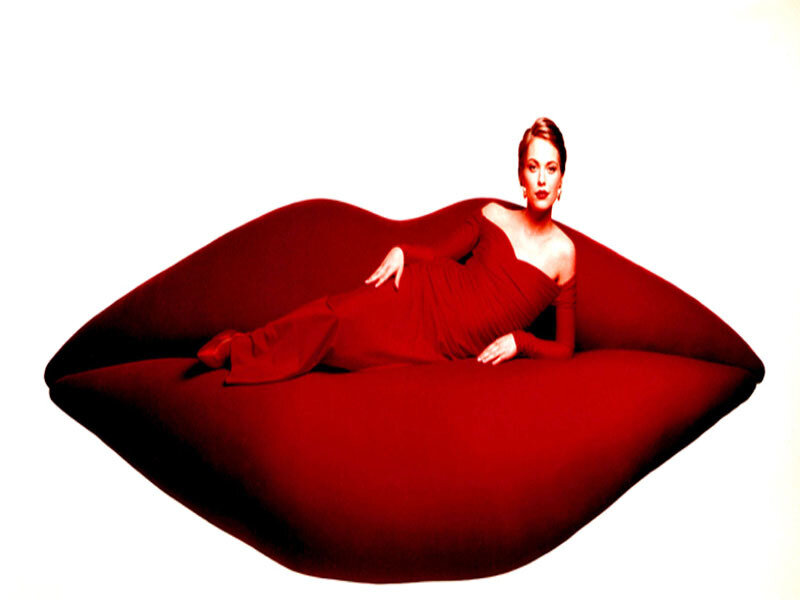 woman on red lip-shaped couch