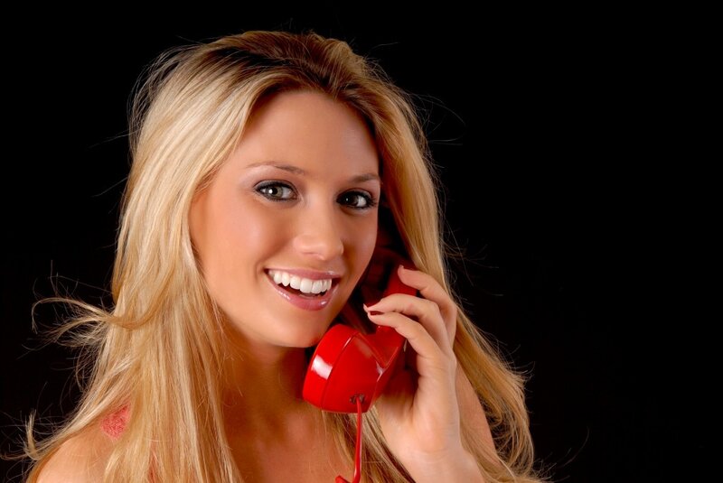 Woman on Red Phone — Smiling