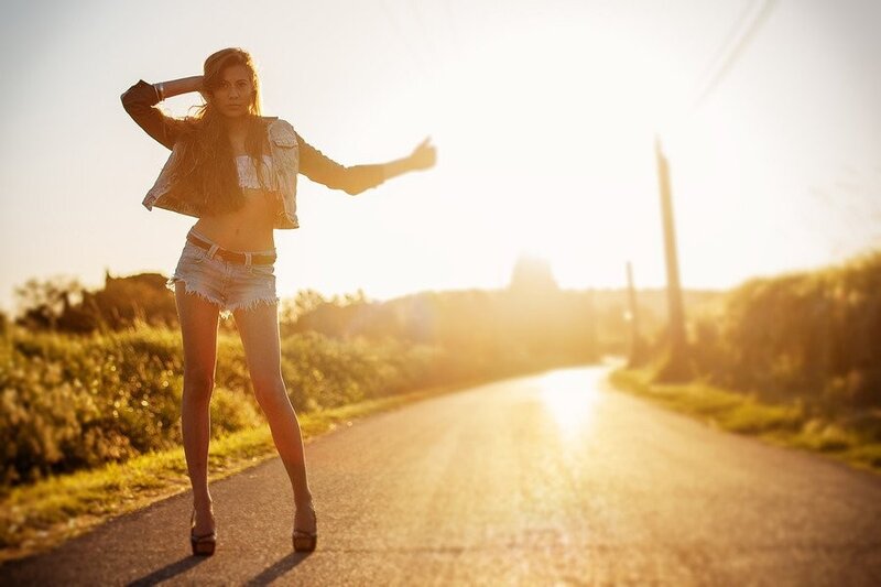 woman on road at sunset