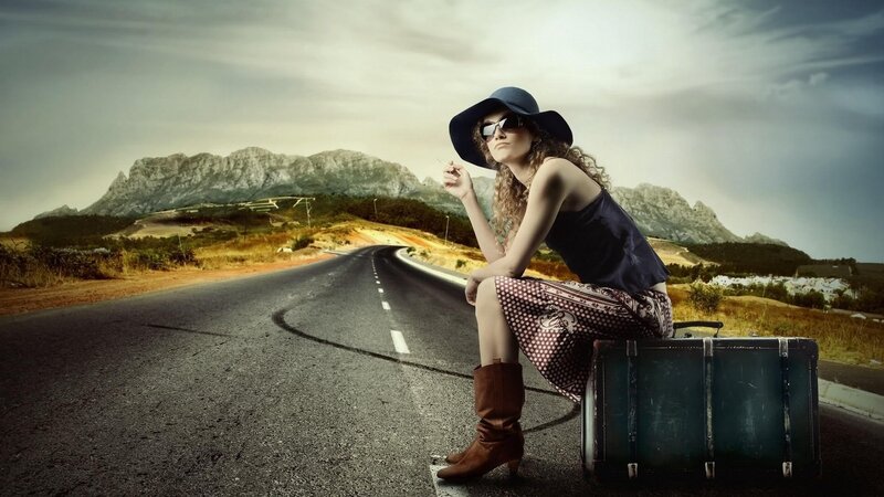 woman on road with suitcase