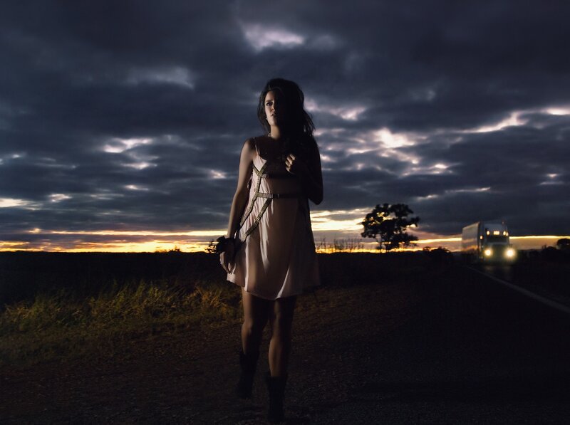 woman on roadside at dusk