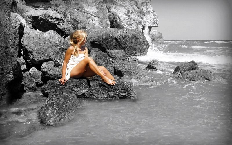 Woman on rocky shore