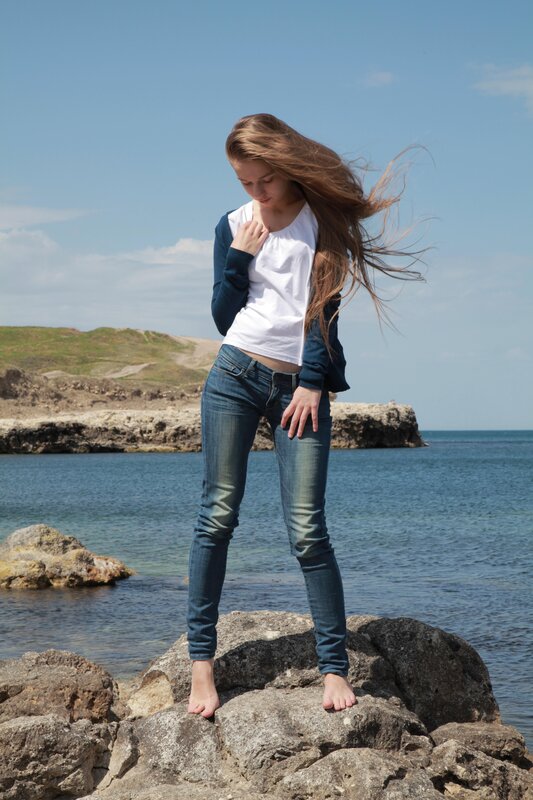 Woman on rocky shore