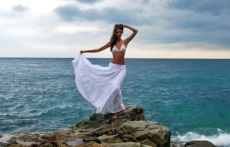 Woman on Rocky Shore — Blue, Dramatic, Afternoon, Photograph