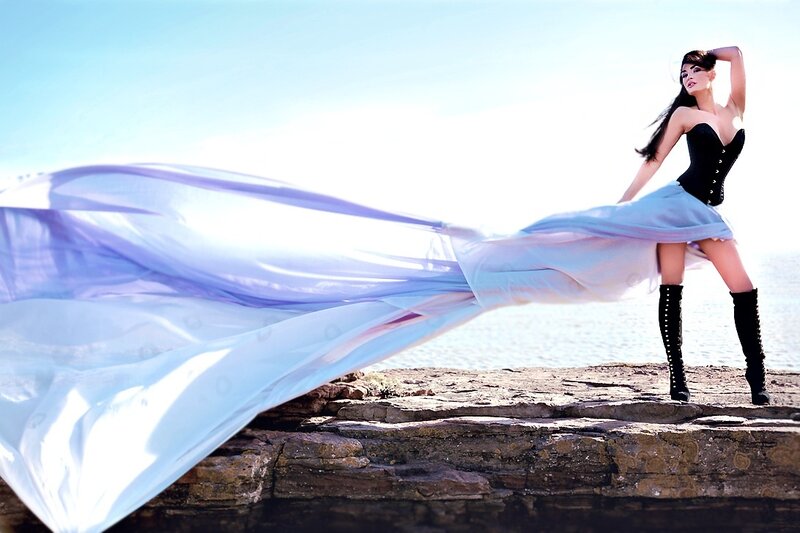 Woman on Rocky Shore — Blue, Dramatic, Afternoon