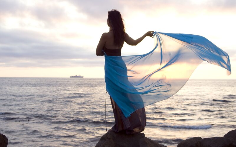 Woman on Rocky Shore — Blue, Serene, Sunset, Photograph