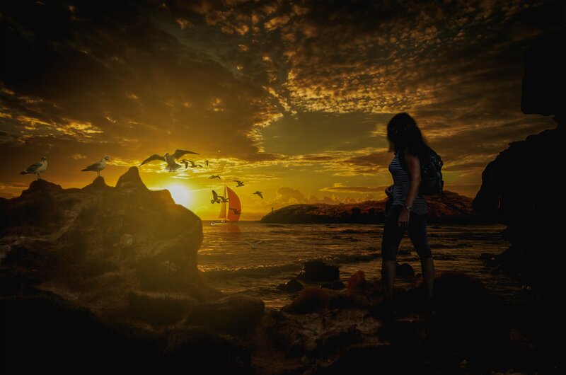 Woman on Rocky Shore — Gold, Dramatic, Sunset