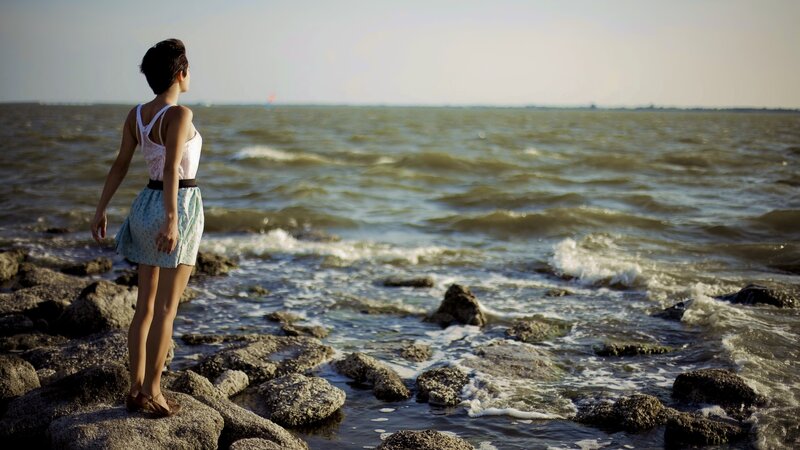 Woman on rocky shore
