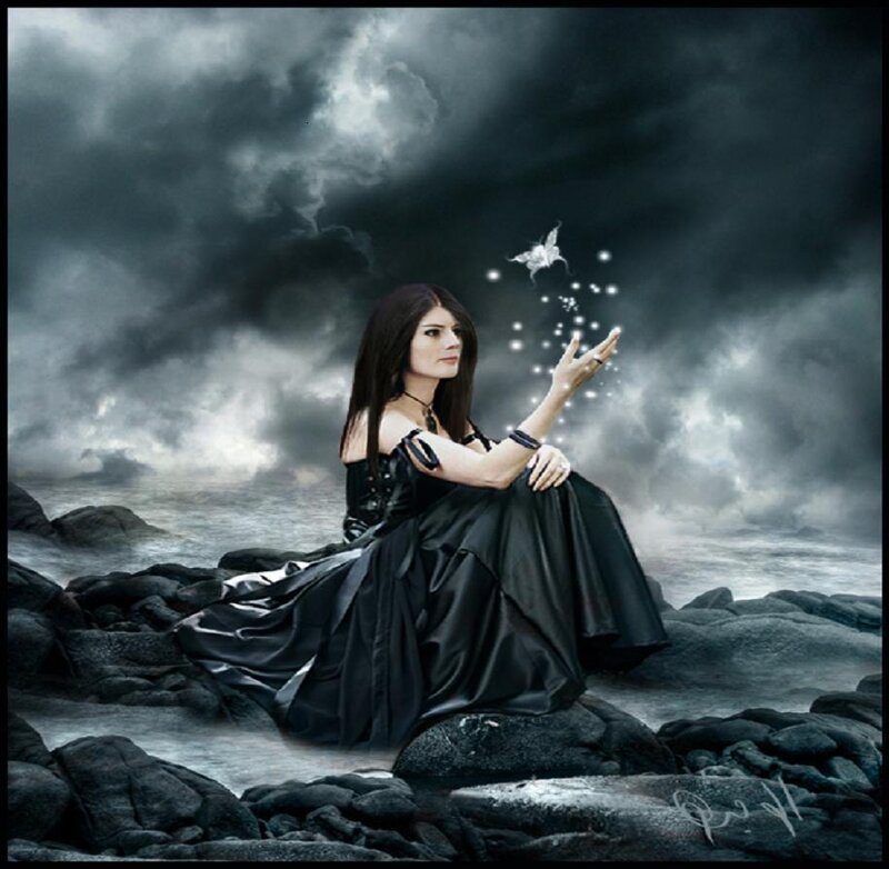 woman on rocky shore with bird