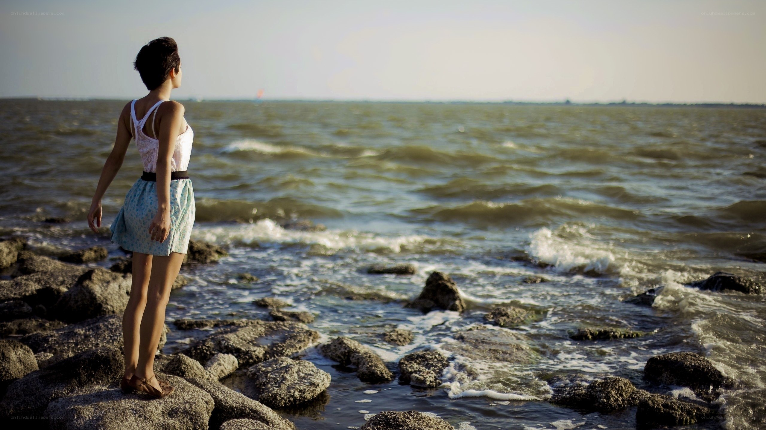 Woman on rocky shore