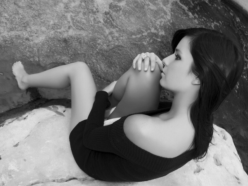 Woman on Rocky Surface — Black, Contemplative