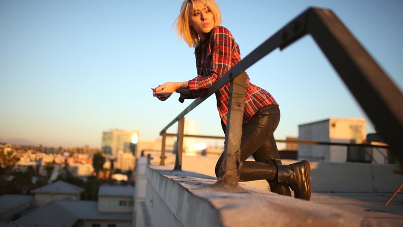 woman on rooftop at sunset