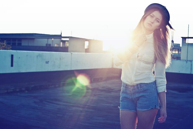 woman on rooftop at sunset