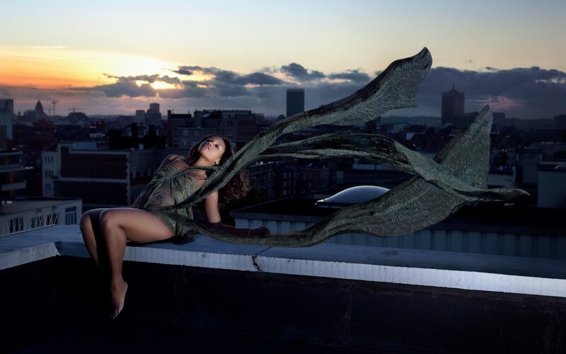 Woman on rooftop at sunset