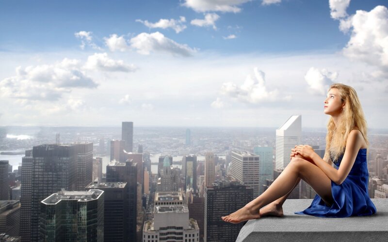 Woman on rooftop overlooking city