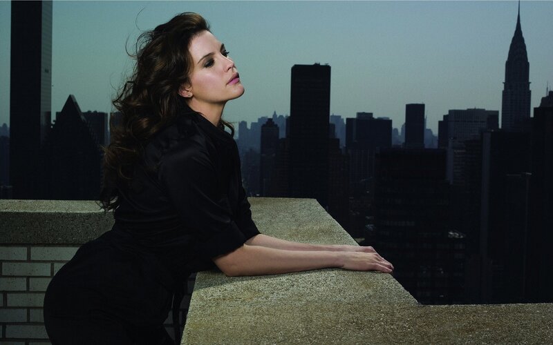 woman on rooftop overlooking city