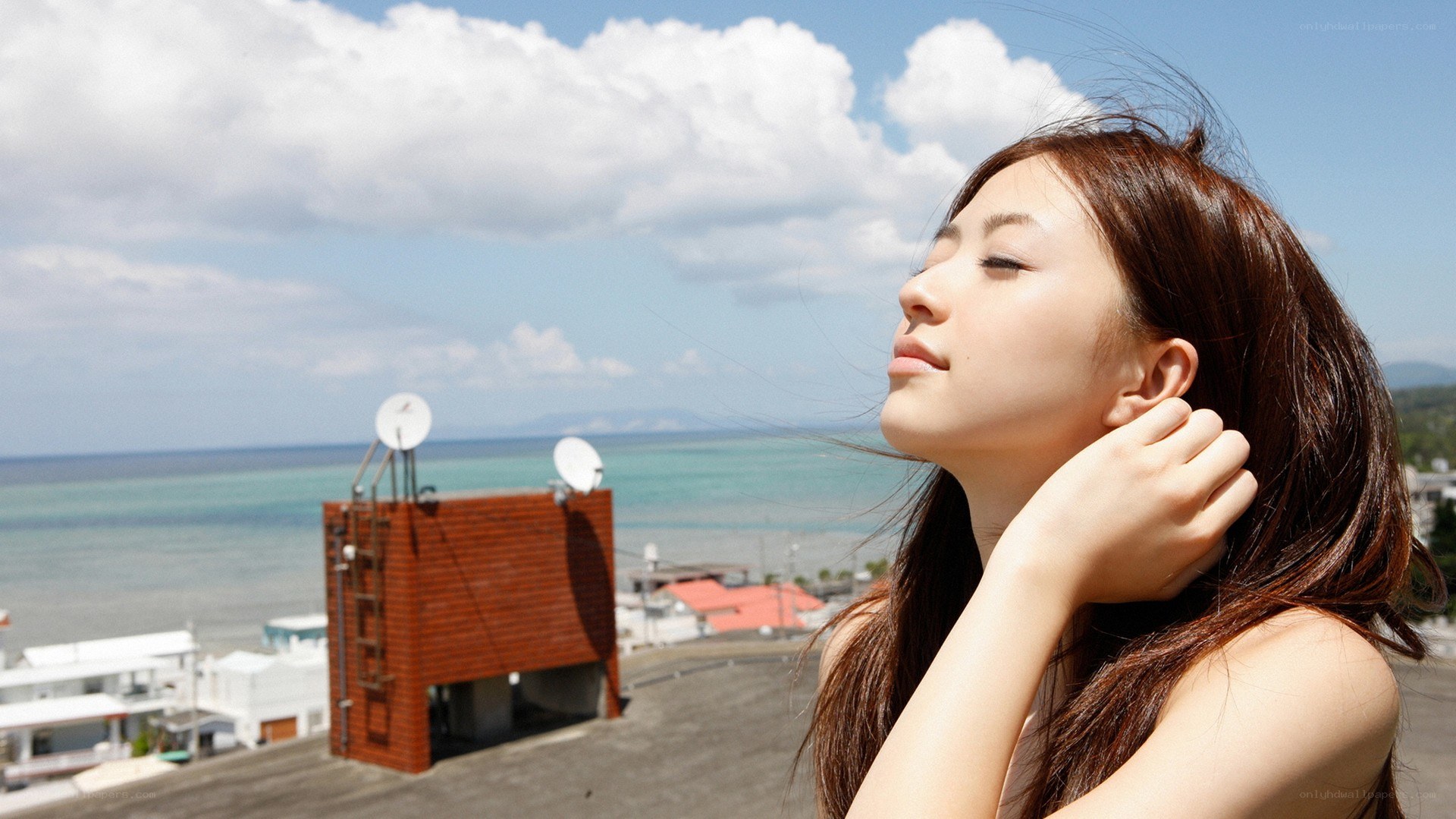 Woman on rooftop overlooking ocean