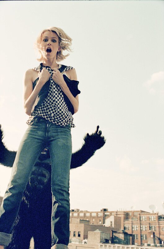 woman on rooftop with animal arms