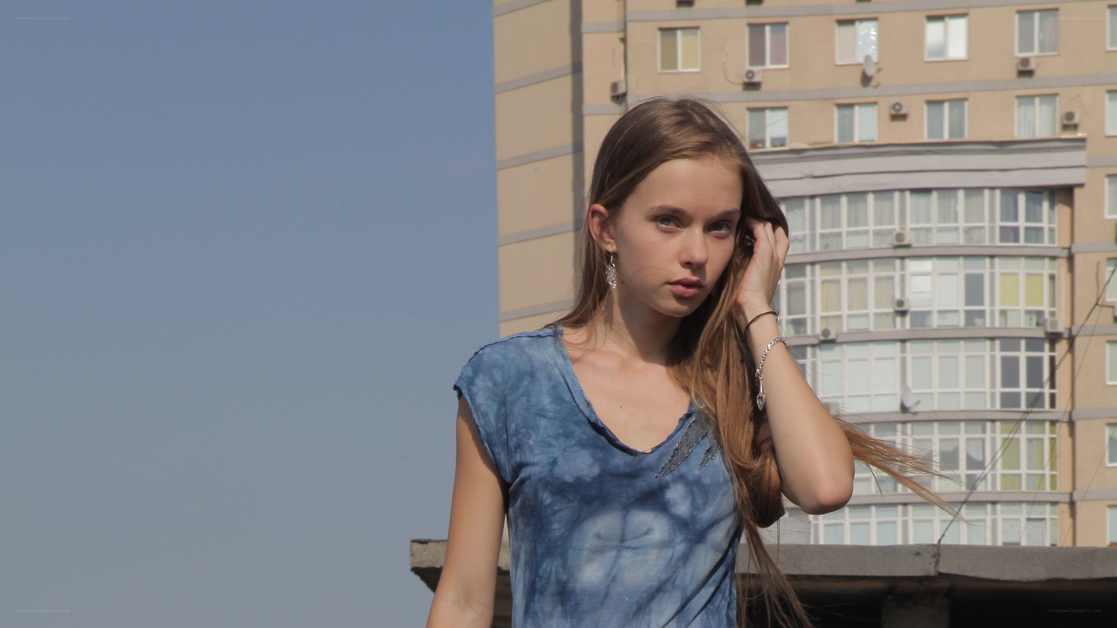 woman on rooftop with building