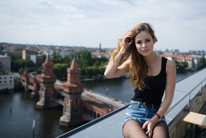 Woman on rooftop with city view