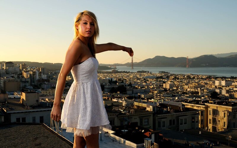 Woman on rooftop with city view