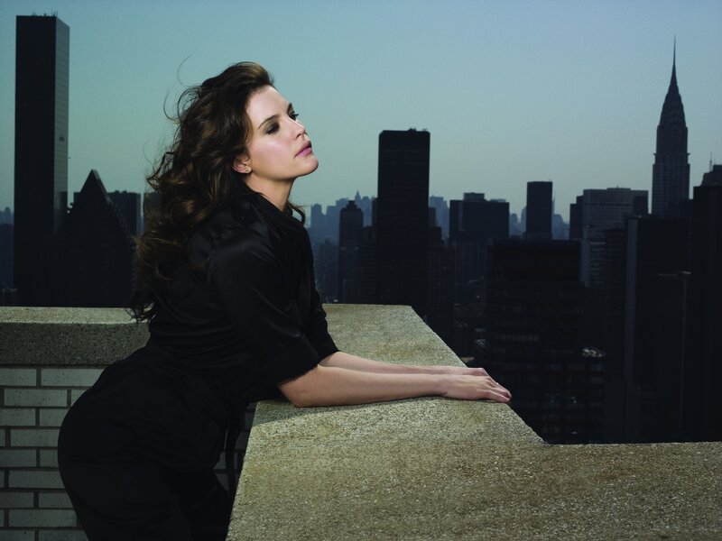 woman on rooftop with city view