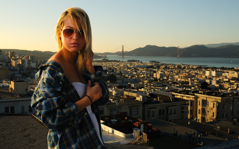 Woman on rooftop with Golden Gate Bridge