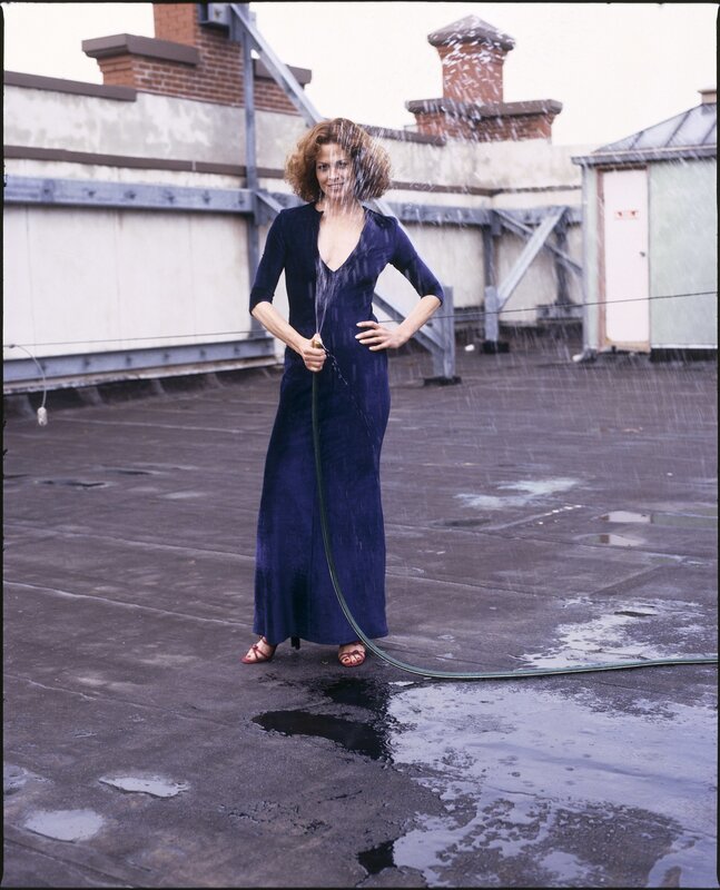 Woman on rooftop with hose