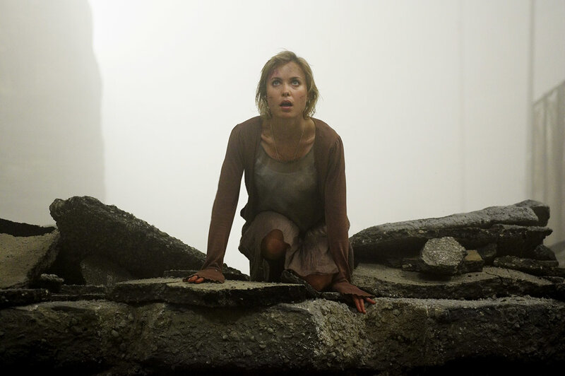woman on rubble in fog