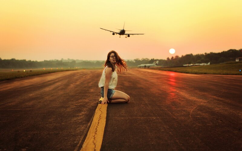 Woman on runway at sunset