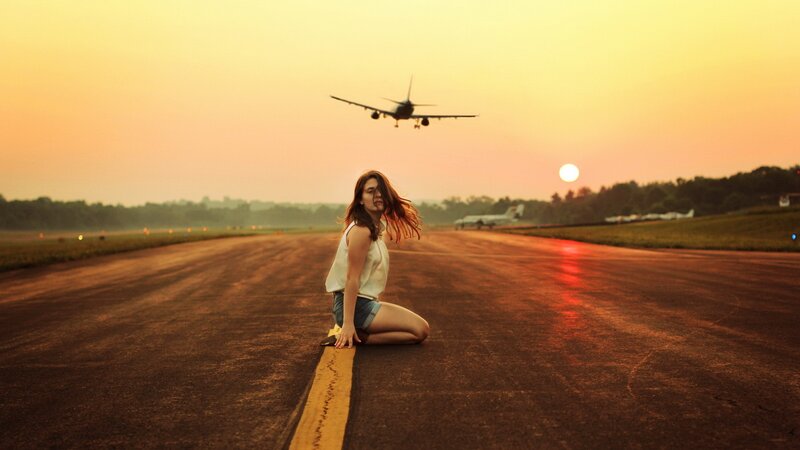 Woman on runway at sunset