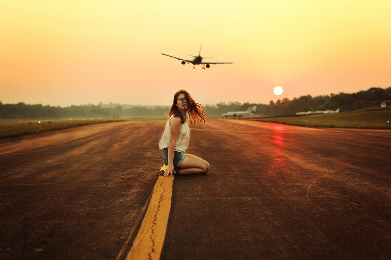 Woman on runway at sunset