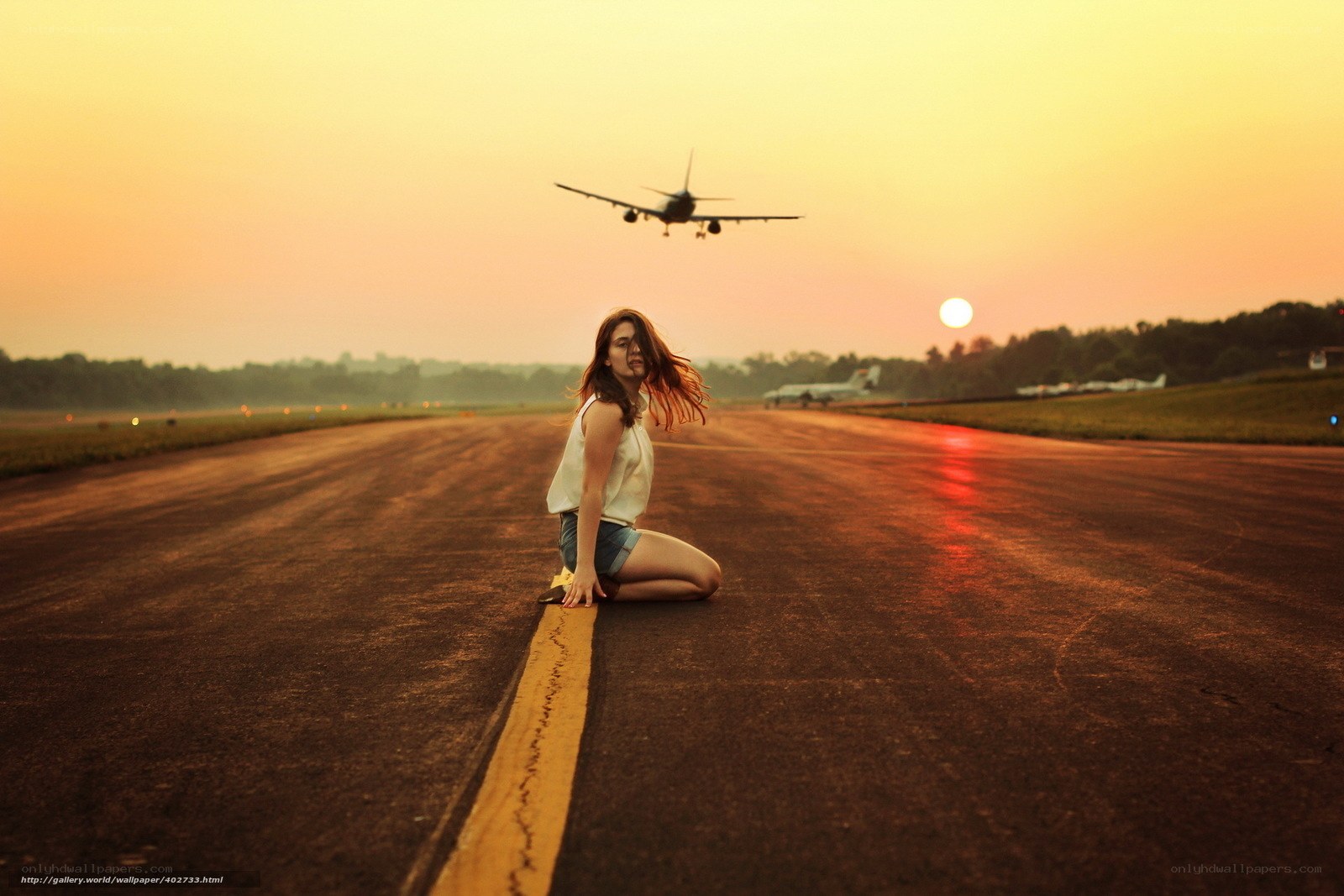 Woman on runway at sunset