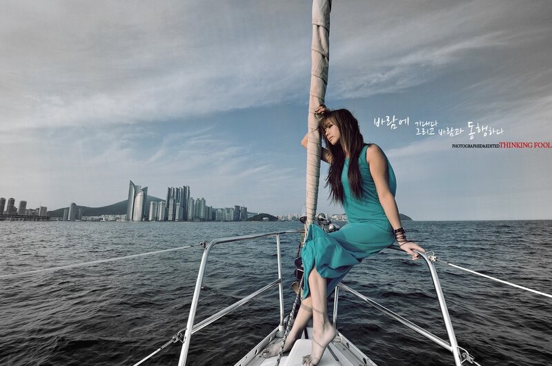 Woman on sailboat with city view