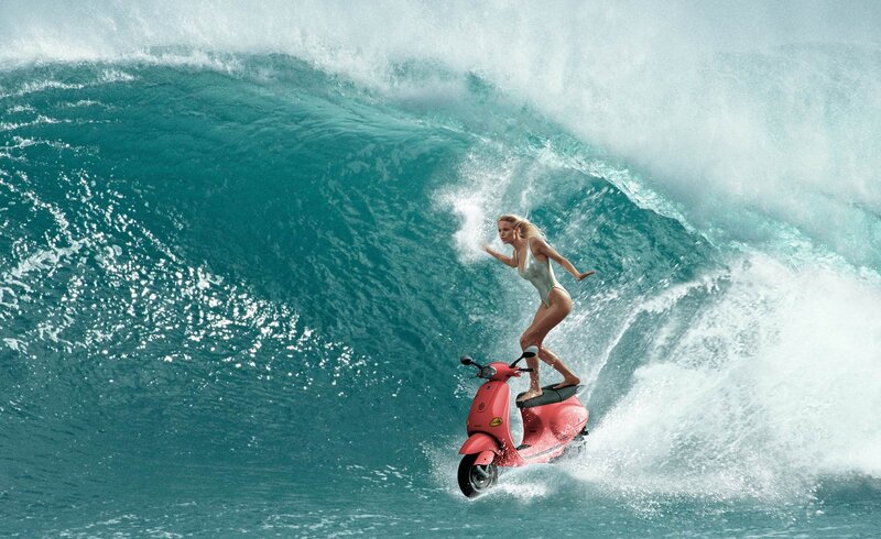 woman on scooter in wave