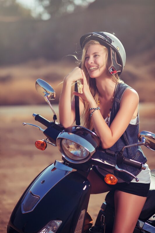 woman on scooter with helmet