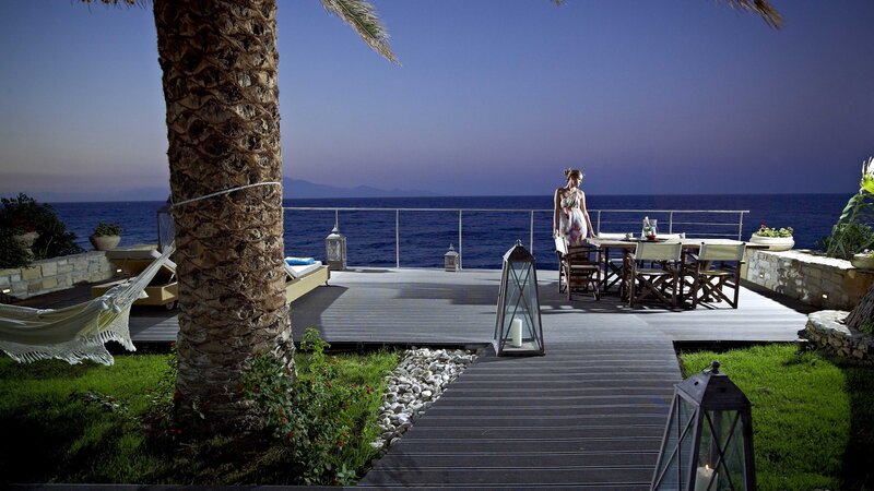 Woman on seaside deck at dusk