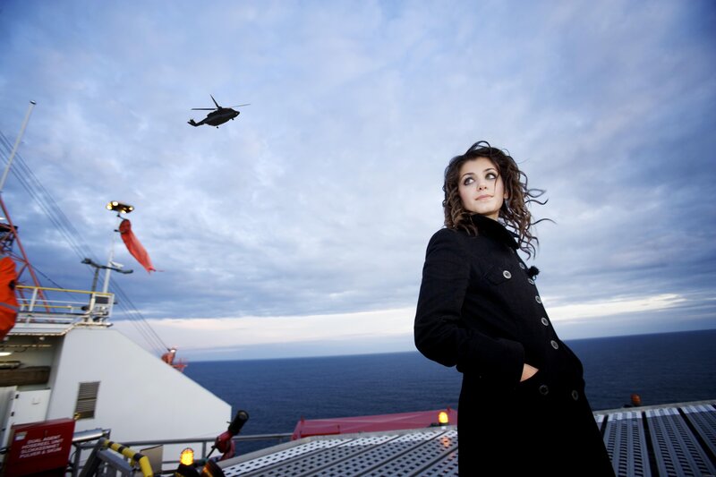 Woman on ship deck with helicopter