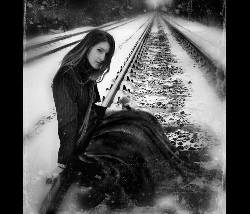 woman on snowy train tracks