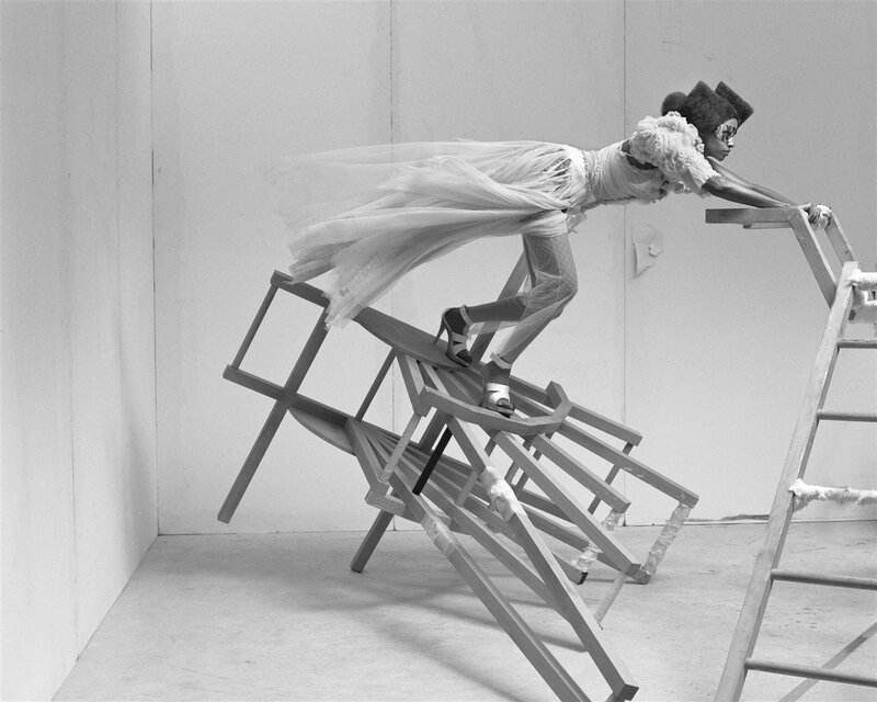 woman on stacked chairs