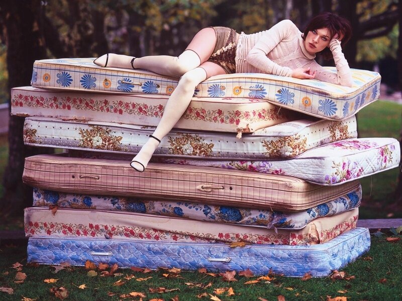 Woman on stacked mattresses
